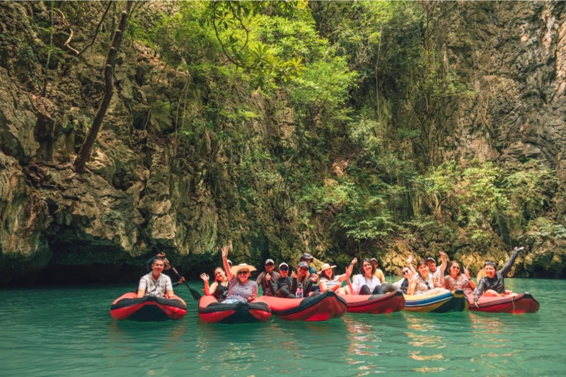A group of tourists enjoying kayaking in the calm waters of Hong Island, Phuket.