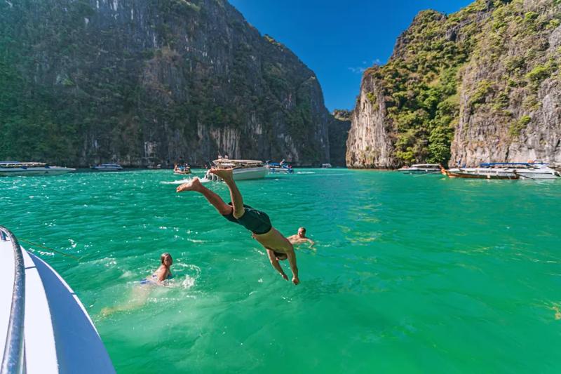 Diving and swimming in the clear waters of Phi Phi Island, Thailand.