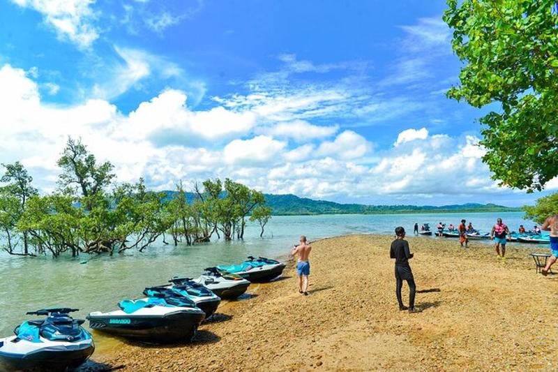 Jetskis parked on the beach, ready for an adventurous ride through Phuket´s mangrove waters.