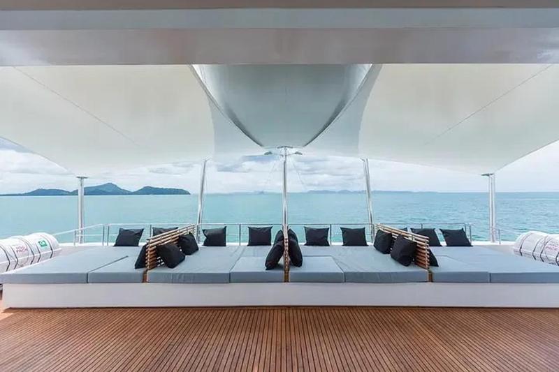 Comfortable yacht lounge area overlooking calm blue waters, designed for ultimate relaxation.